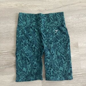 GymShark teal printed biker shirts in size medium.